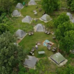 A stunning drone view capturing the entire lakeside camping site at My Adventure Zone.