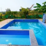 The relaxing swimming pool area at the farmhouse stay property of My Adventure Zone.