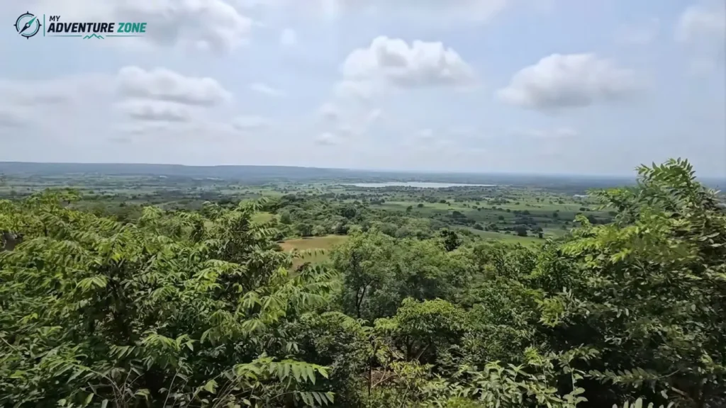 Panoramic hilltop view of green valley and distant lake from Ananthagiri Hills viewpoint Vikarabad