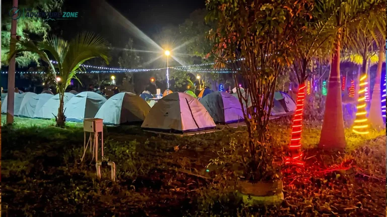 Row of waterproof tents and fairy lights for weekend night camping near Hyderabad in Ananthagiri Hills